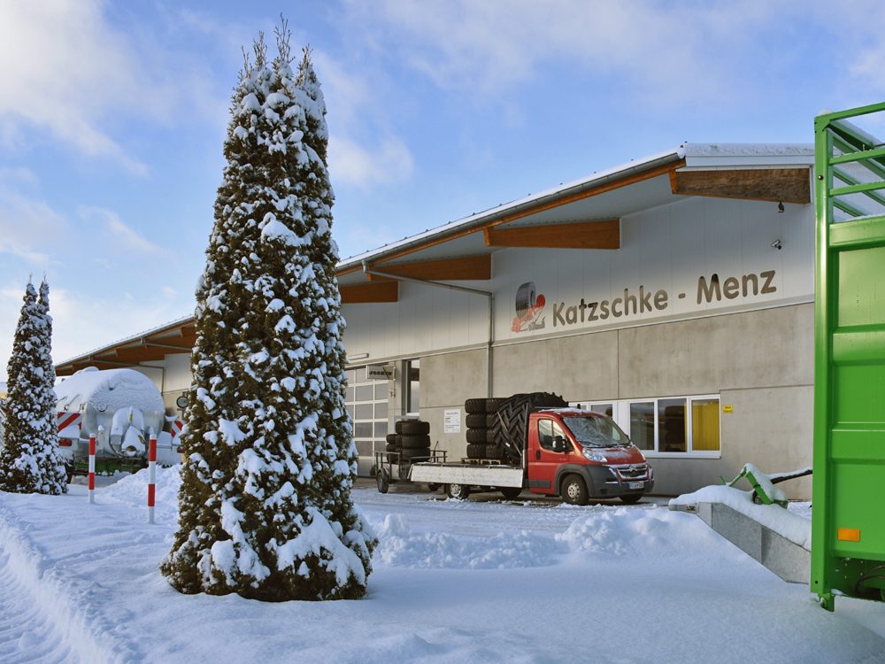Firmengebäude von Katzschke-Menz in Isny im Schnee mit verschneitem Baum und Firmenfahrzeug